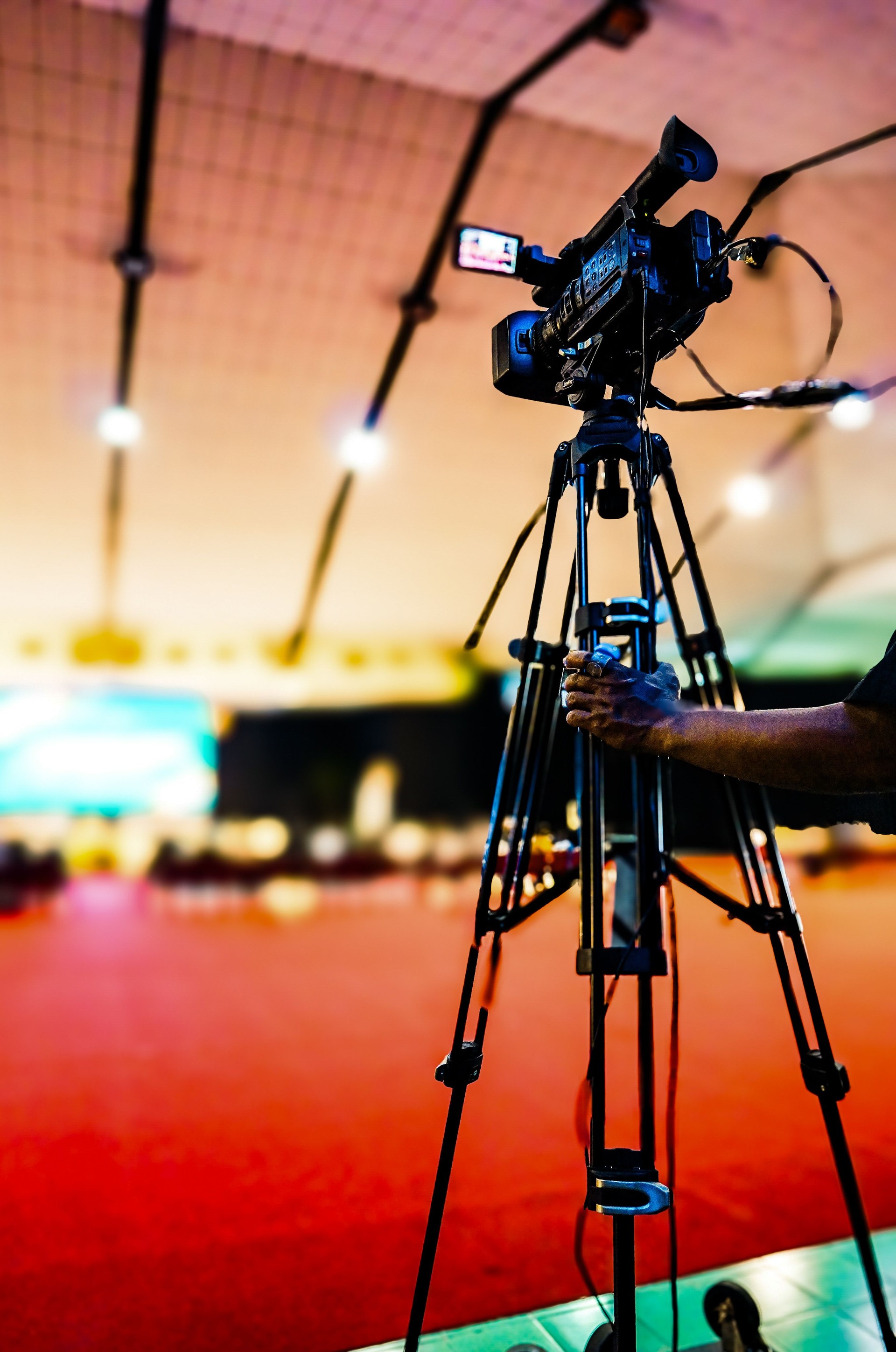 A photographer records live streaming video of lecturers and students learning in university.